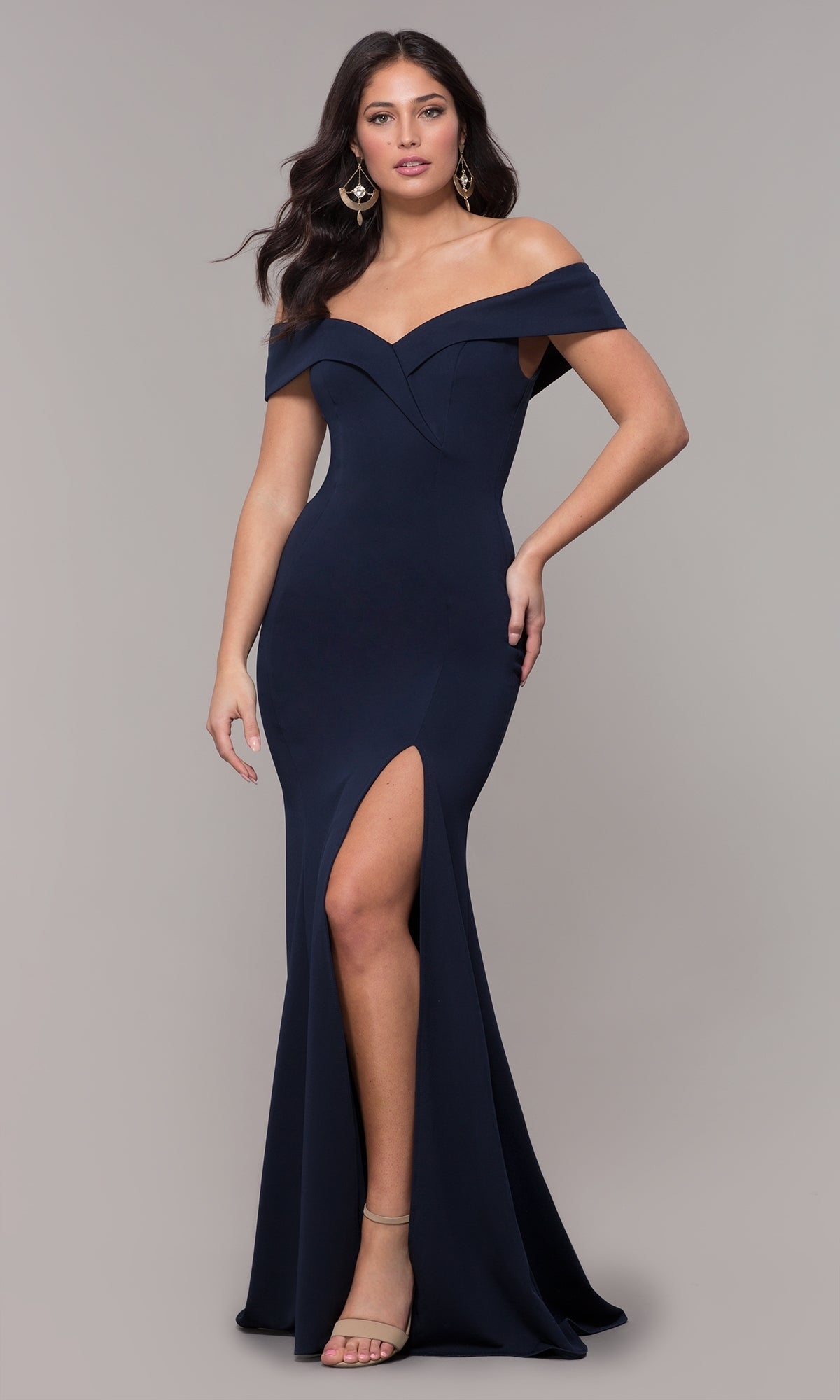 A woman models the Classic Off-the-Shoulder Formal Prom Dress 8258 in navy, featuring a fitted silhouette and thigh-high slit, set against a plain light gray background.